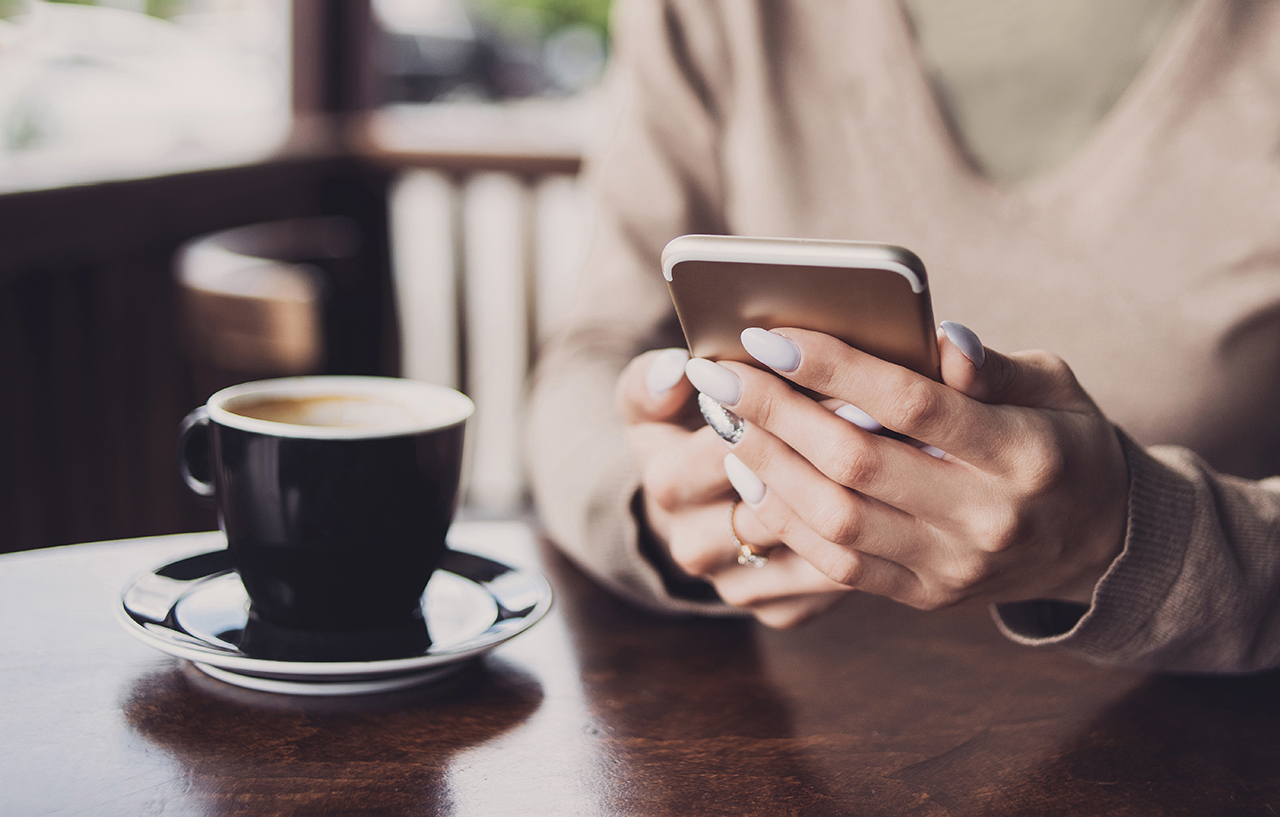 Girl-using-smart-phone-in-coffee-shop at Crescent Pointe located in the foothills of South Carolina